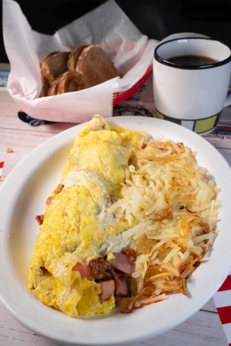 Fluffy omelette served with crispy hash browns and coffee